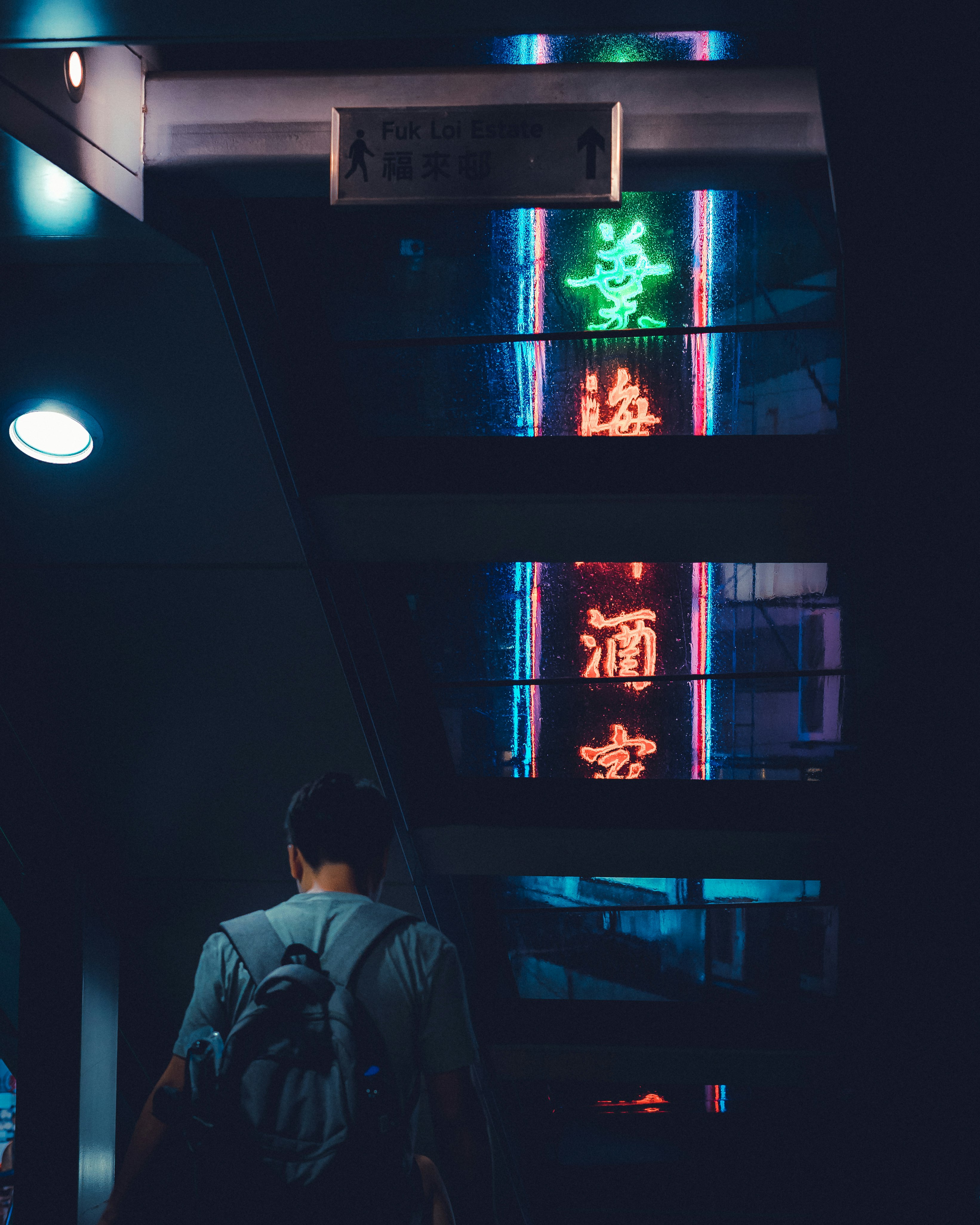 man holding blue backpack